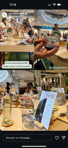 Décor de vitrine scénographique avec installation de tables, brochures, et dégustation de vin dans un espace lumineux, créant une ambiance conviviale et professionnelle.