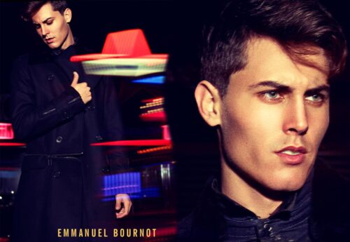 Mannequin masculin posant en tenue élégante noire, ambiance urbaine nocturne avec éclairages colorés en arrière-plan, style sophistiqué et regard assuré.